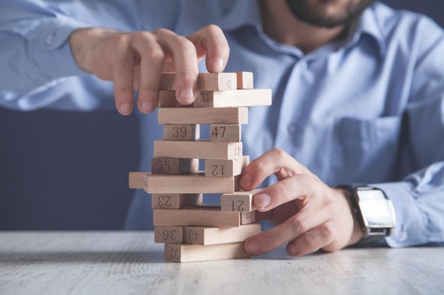 Man with wooden blocks. Business concept