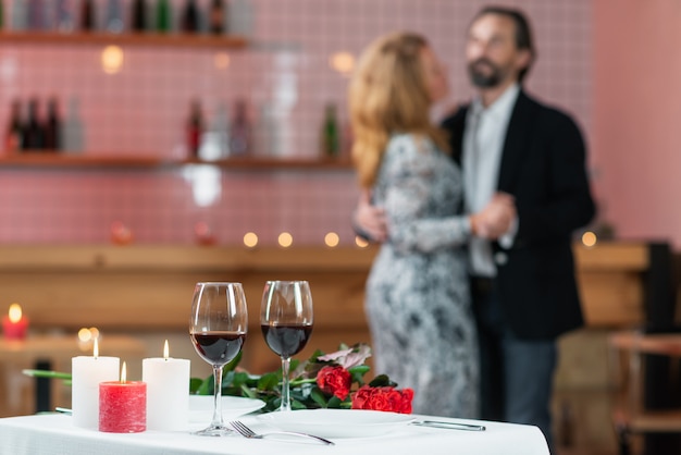 Man and woman are dancing in a cafe, soft focus