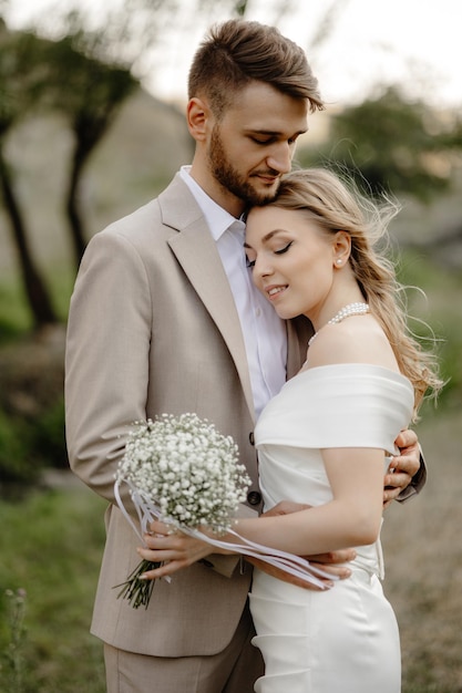 Photo a man and woman are embracing in a field