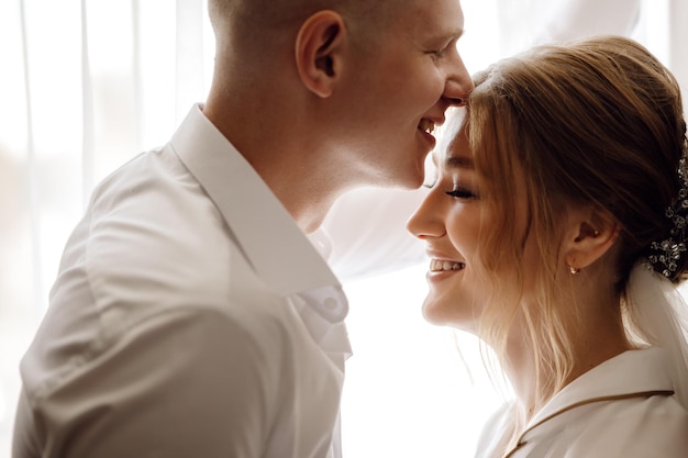 A man and a woman are looking at each other and smiling.