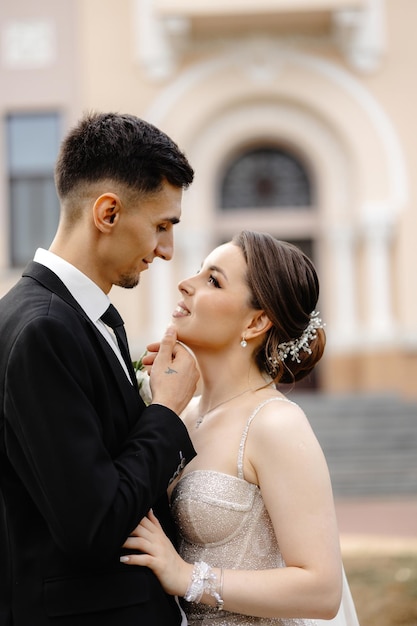 a man and woman are looking at each other and the woman is wearing a tiara