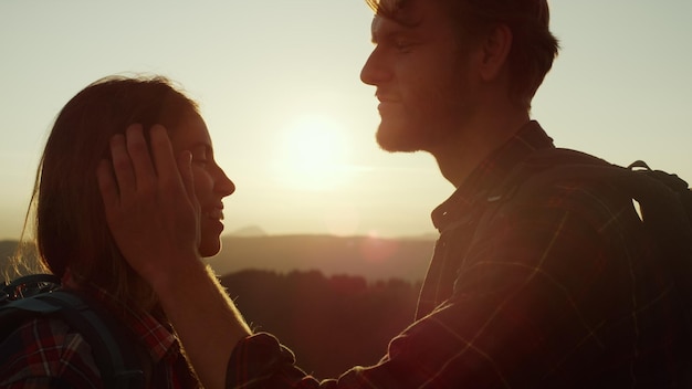 A man and a woman are looking at the sunset.