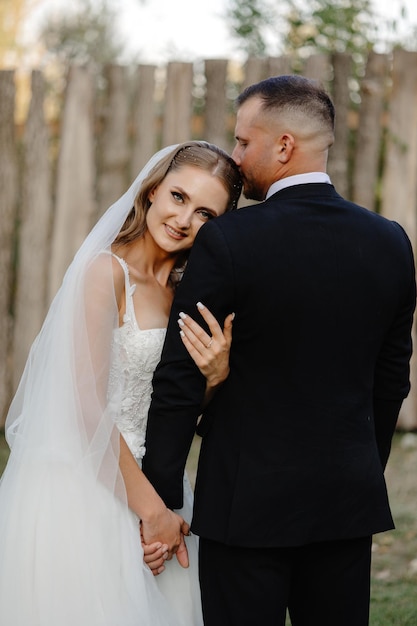 a man and a woman are posing for a photo in the woods