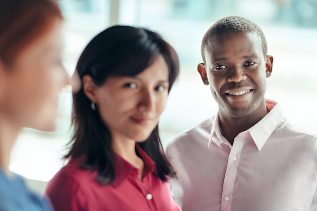 a man and woman are smiling and a woman is wearing a pink shirt