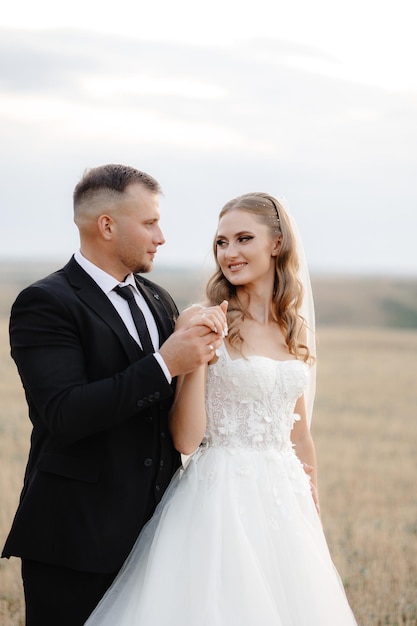 a man and woman are standing in a field