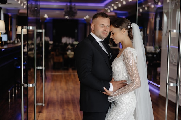 a man and a woman are standing together in a room