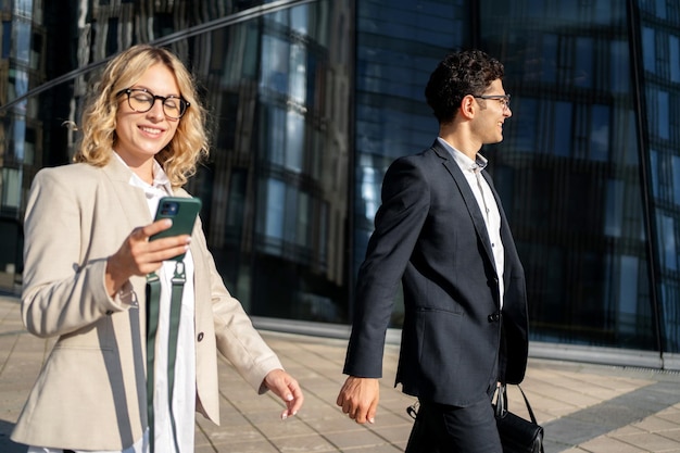 A man and a woman are successful partners managers going to the office for a meeting