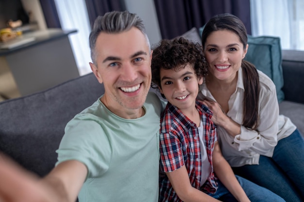 Man woman and boy smiling at camera