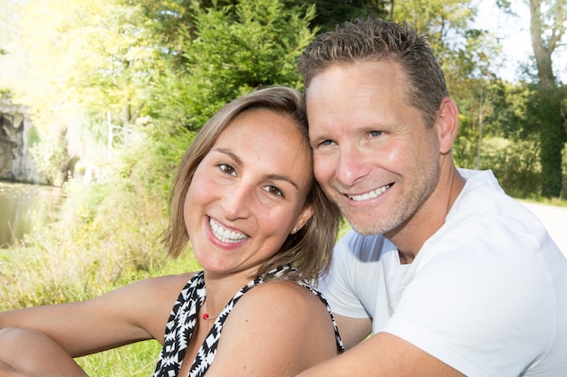 Man and woman in braces laughing outdoors