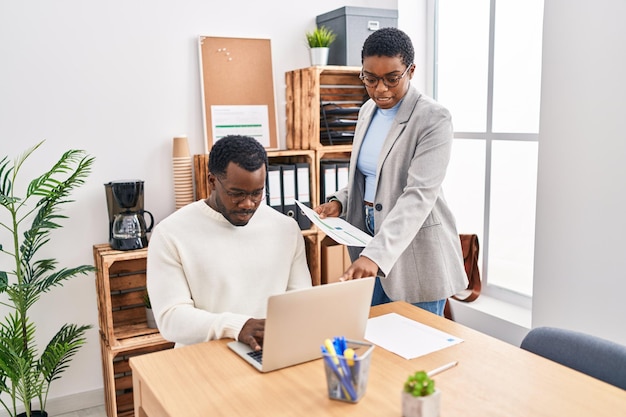 Man and woman business workers using laptop working at office