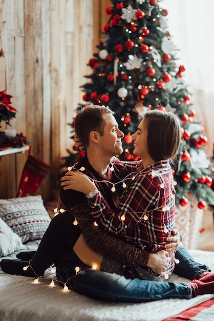 Man and woman celebrate Christmas together in a warm atmosphere at home