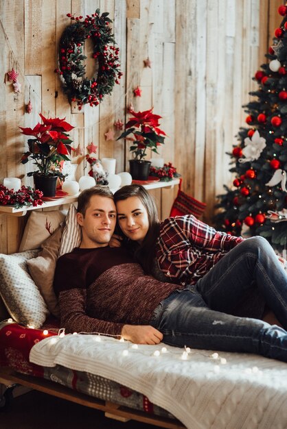 Man and woman celebrate Christmas together in a warm atmosphere at home