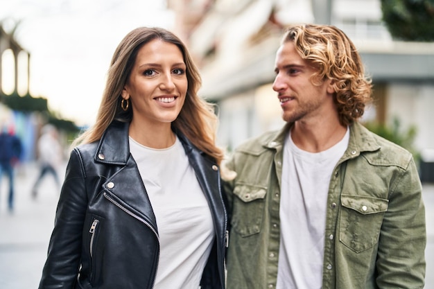 Man and woman couple smiling confident standing together at street