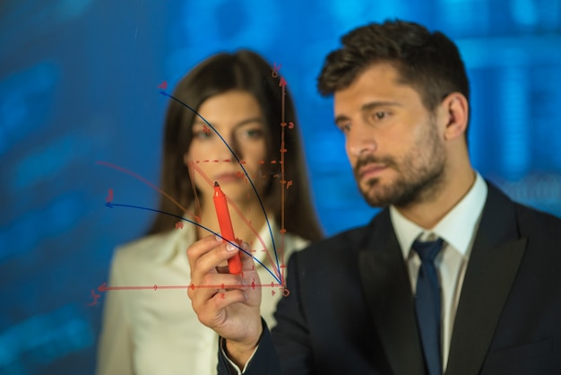 The man and woman drawing on the virtual board