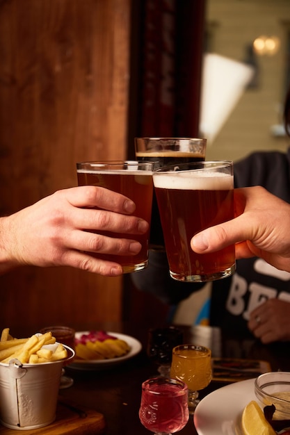 Man and woman drink beer in pub Friends having alcoholic drinks in the bar