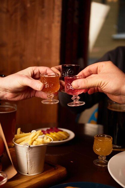 Man and woman drink different liquors in pub Friends having alcoholic drinks in the bar