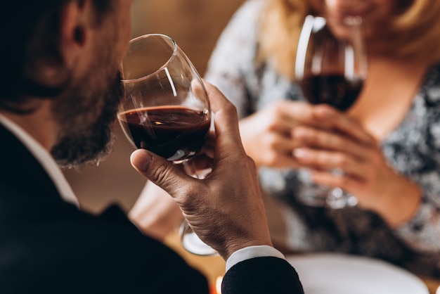 Man and woman drink red wine close up