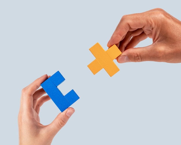 Man and woman hands joining two puzzle pieces Partnership connection concept Mutual understanding support in relations