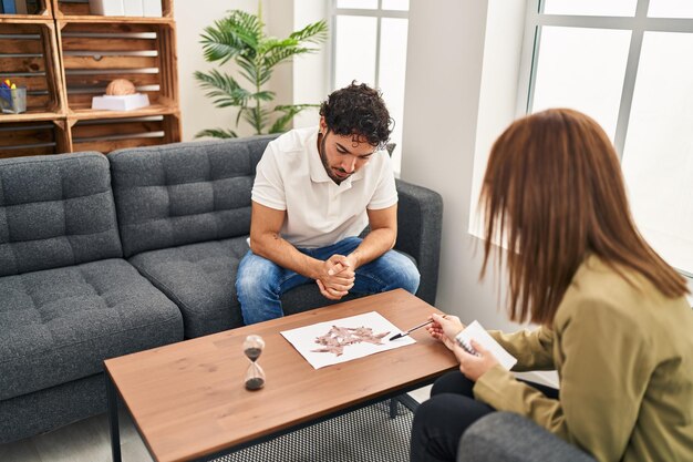 Man and woman having rorscharch test session at psychology center