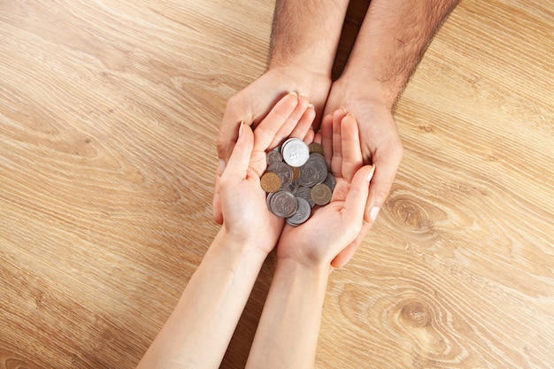 Man and woman holding coins