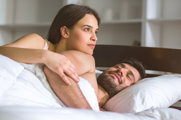 The man and woman lay on the bed