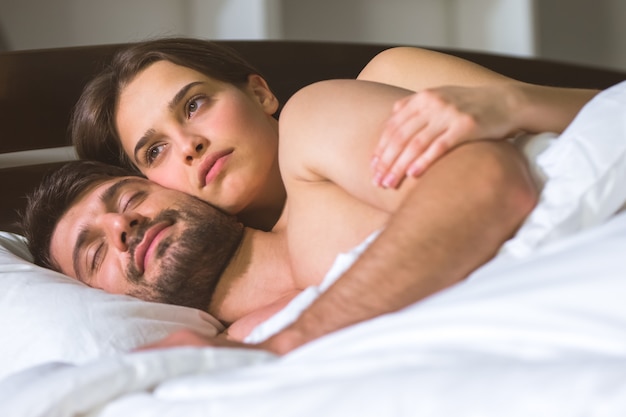 The man and woman lay on the bed