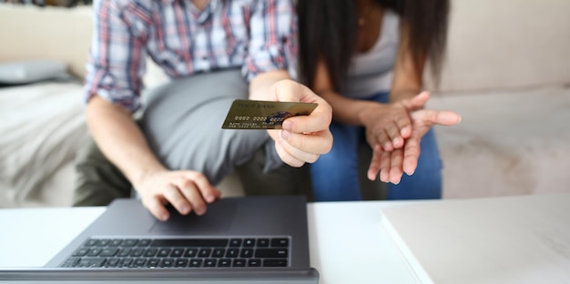 Man and woman learning how to pay via pc