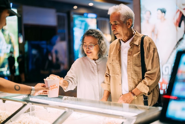 a man and a woman looking at a display of ice cream