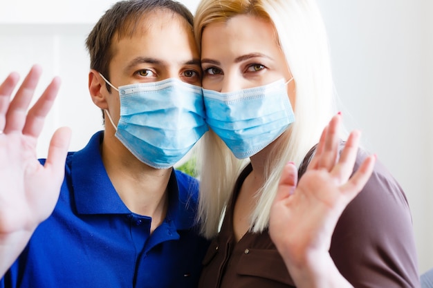 Man and woman in a medical mask. Family portrait during a pandemic. Protective medical face mask. Covid 19 Pandemic Virus Protection.