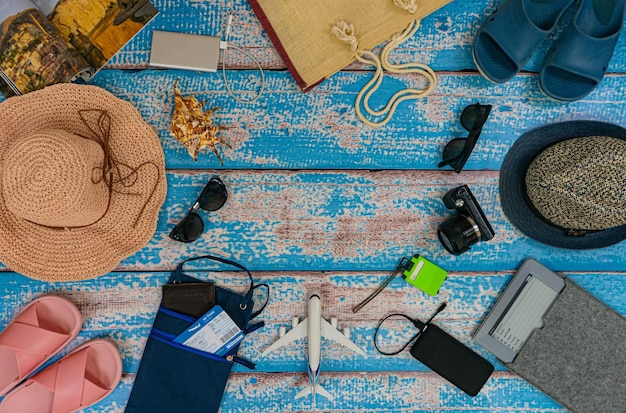 Man and woman pair vacation accessories on the blue wooden boards Concept family going on vacation