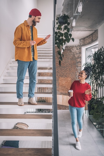 A man and a woman. Picture of a man with a phone and a woman with a coffee cup