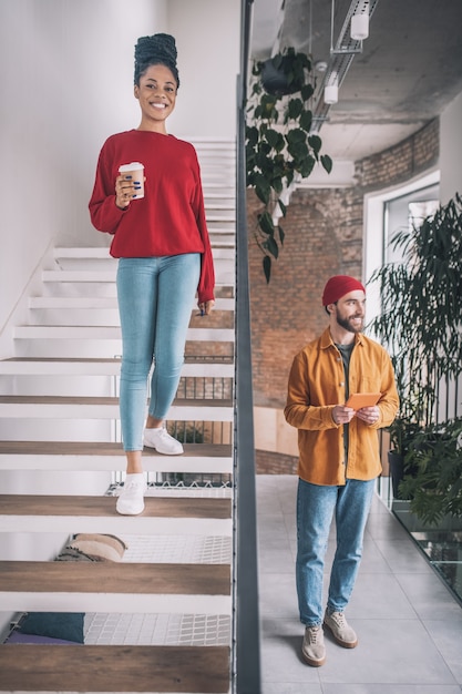 A man and a woman. Picture of a man with a phone and a woman with a coffee cup