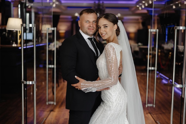 a man and woman pose for a photo in front of a mirror