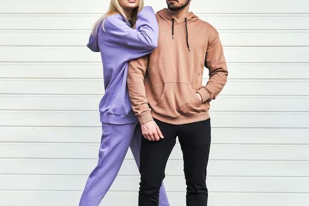 Photo man and woman posing in casual hoodies for an urban fashion mockup