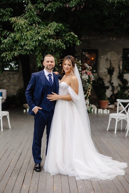 a man and a woman posing for a photo in front of a tree