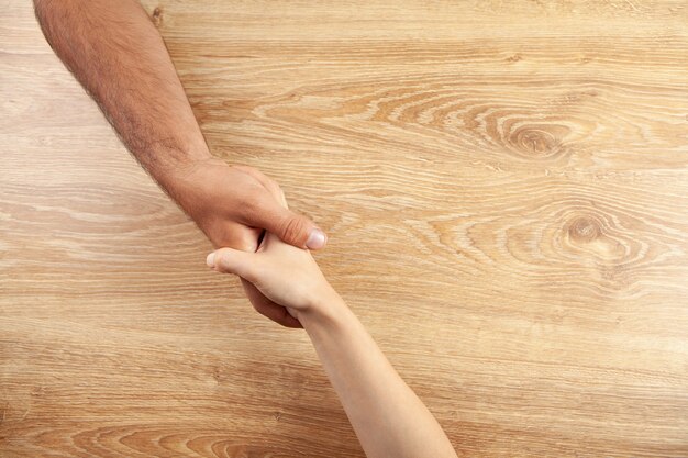 Man and woman shake hands. view from above