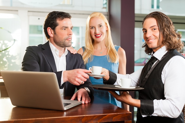 a man and a woman sitting in cafe