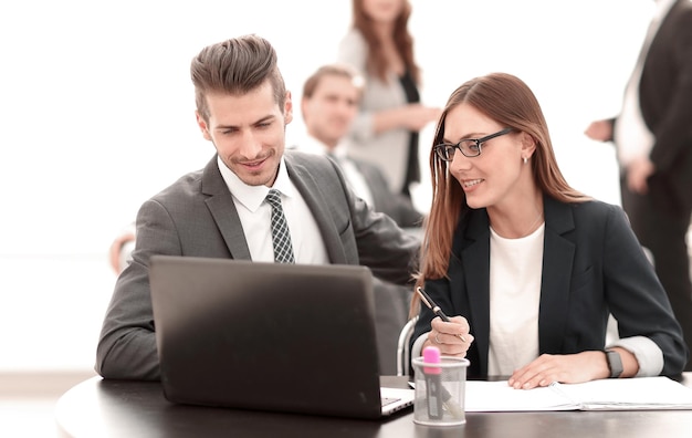 Man and woman sitting at table in coworking office