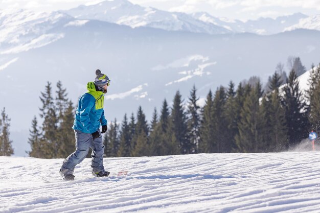 Man and woman skiing and snowboarding in the mountains ski resort