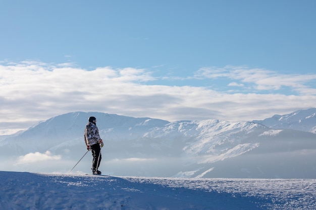 Man and woman skiing and snowboarding in the mountains ski resort