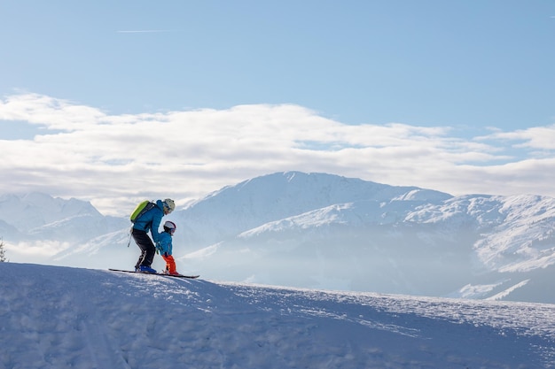 Man and woman skiing and snowboarding in the mountains ski resort