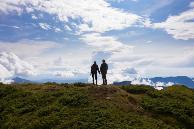 The man and woman standing on the beautiful mountain