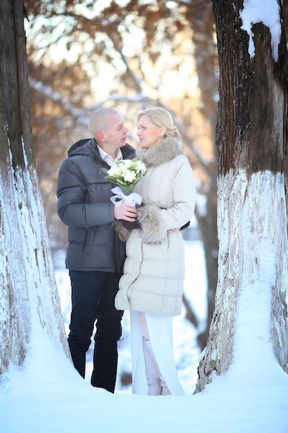 man and woman walking on the street in winter wedding