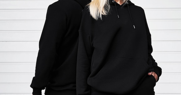 Man and woman wear black hoodie without a logo Long sleeve dark sweatshirt mockup Basic clothing sportswear