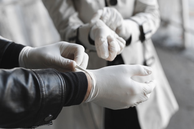 Man and woman wears medical gloves to be safe from the outbreak of novel coronavirus. Wearing hand gloves can prevent the covid-19 coronavirus