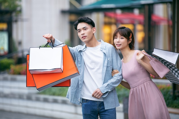 Man and woman with colorful shopping bags