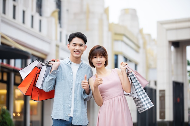 Man and woman with colorful shopping bags