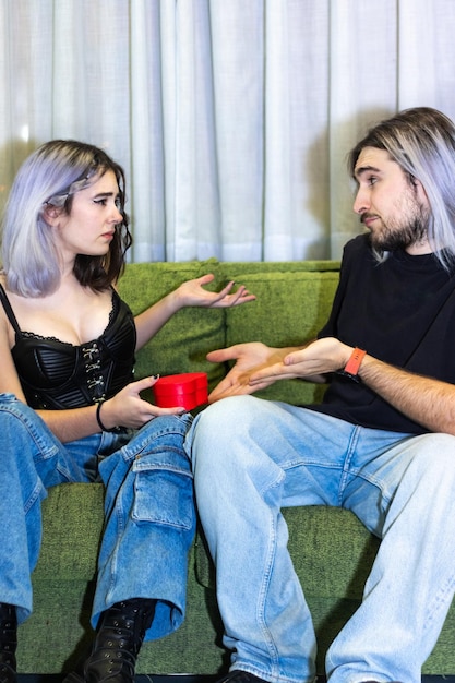 Man and woman with a gesture of disgust when he received a rose as a gift from his couple