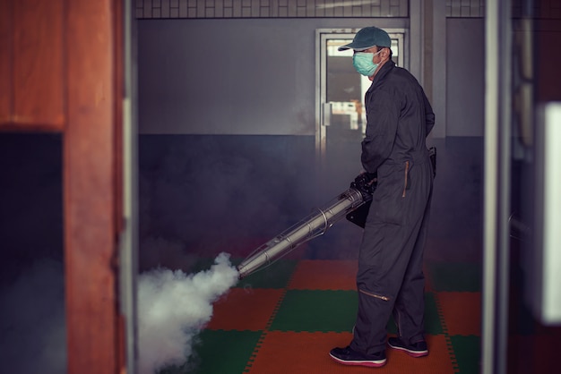 Man work fogging to eliminate mosquito