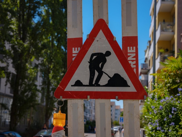 Man At Work Sign On Road